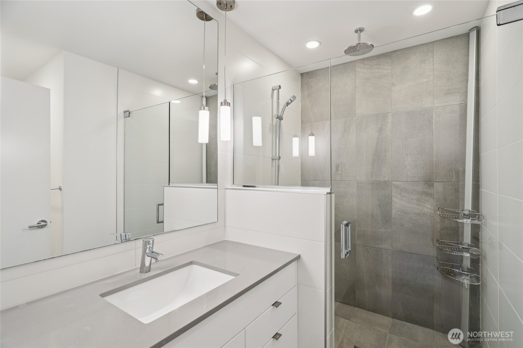 1117 Northwest 56th Street, Unit D Seattle, WA 98107 - Photo 16 of 32 a bathroom with a shower sink and mirror