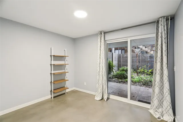 a view of room with balcony and wooden floor