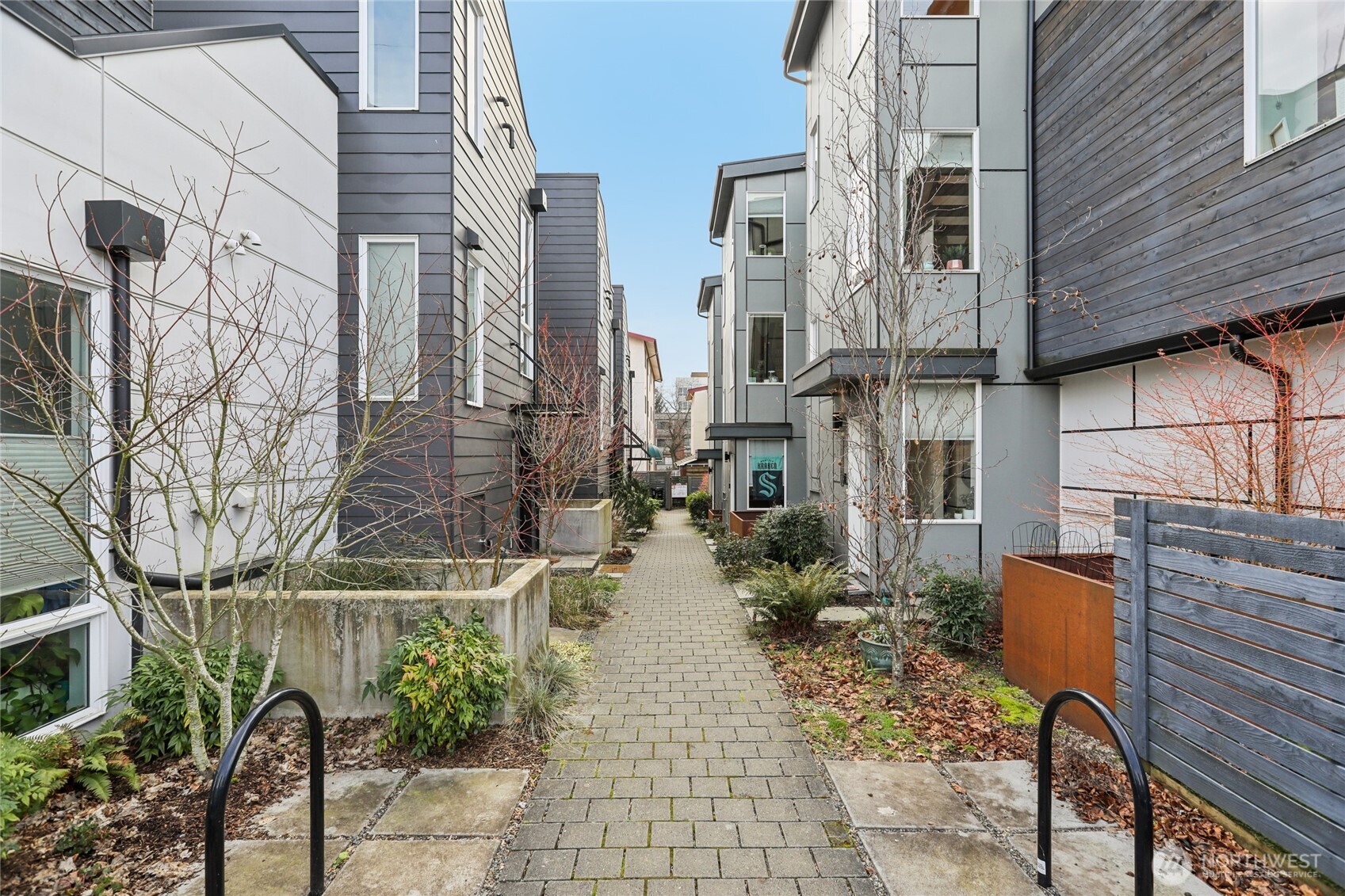 1117 Northwest 56th Street, Unit D Seattle, WA 98107 - Photo 2 of 32 a view of a patio with table and chairs and potted plants