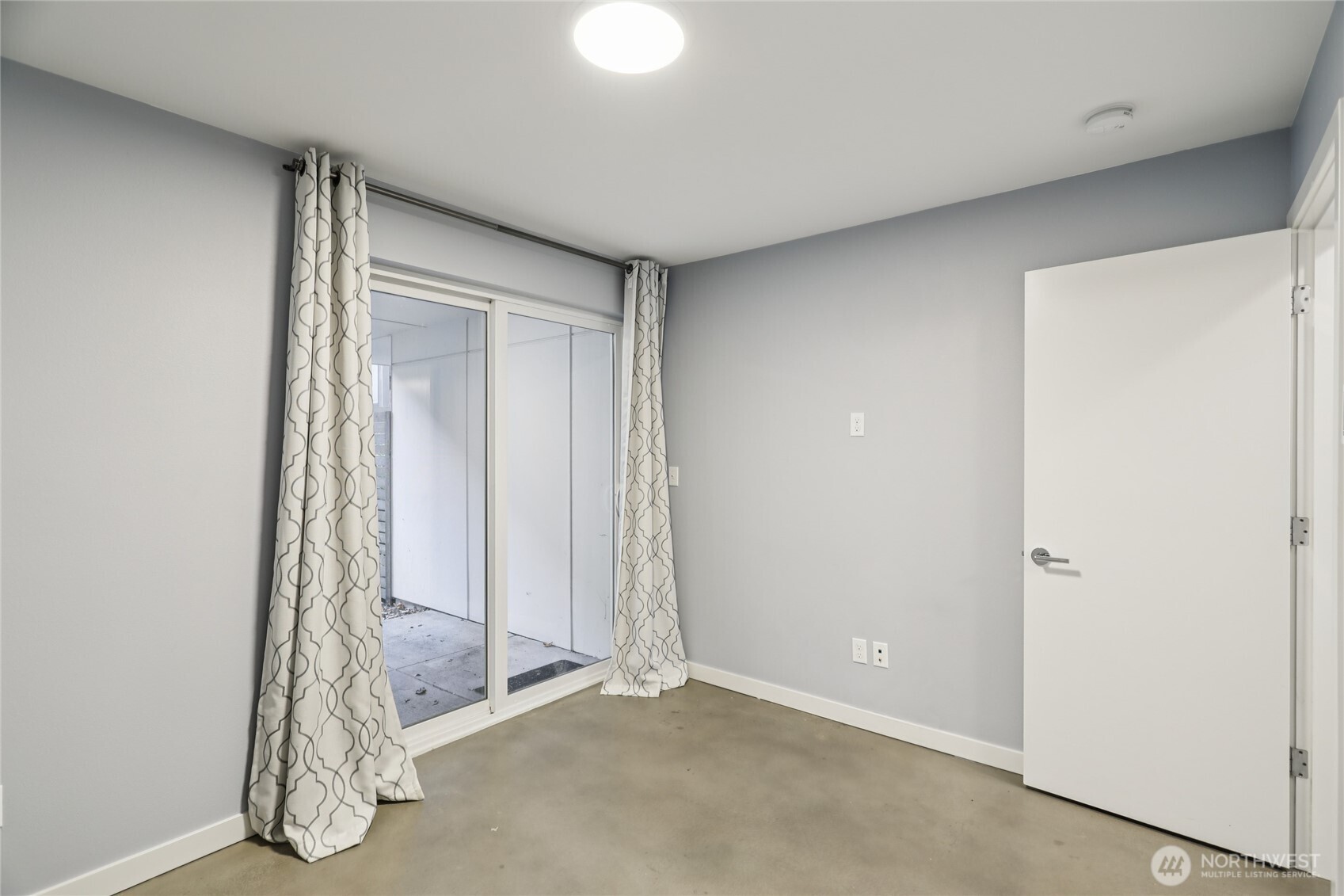 1117 Northwest 56th Street, Unit D Seattle, WA 98107 - Photo 21 of 32 an empty room with windows