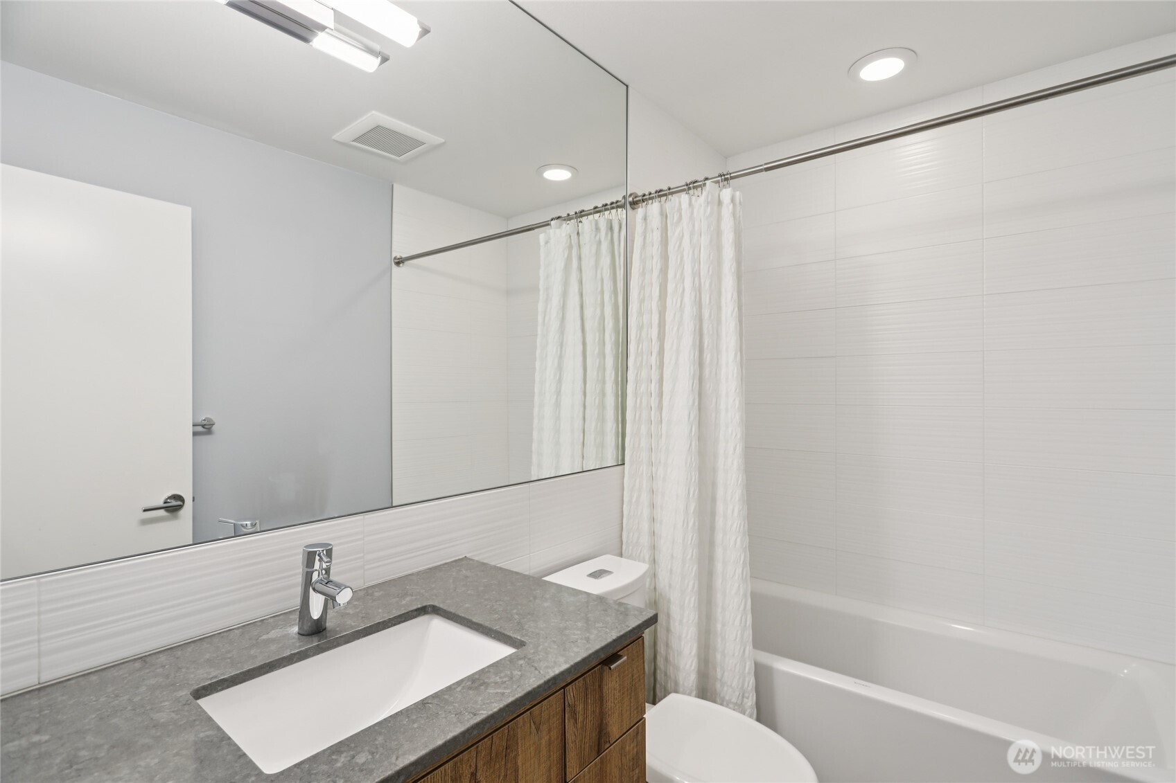 1117 Northwest 56th Street, Unit D Seattle, WA 98107 - Photo 23 of 32 a bathroom with a sink toilet and shower
