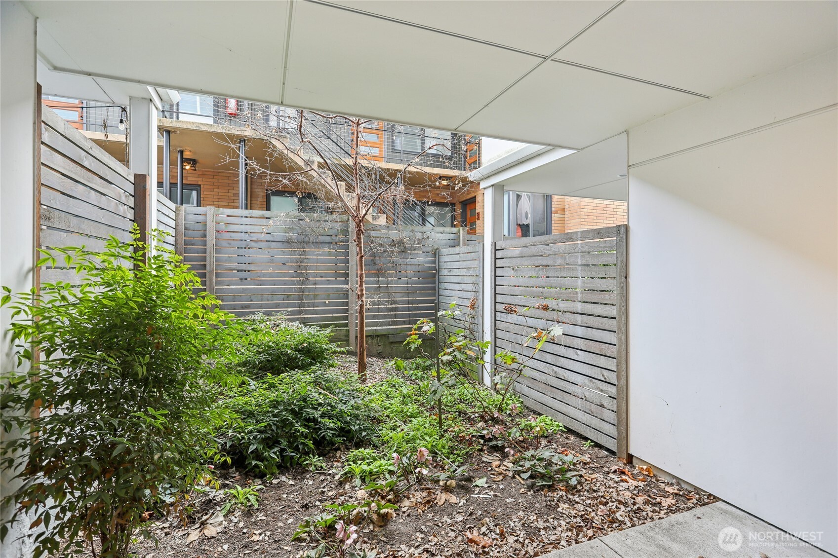 1117 Northwest 56th Street, Unit D Seattle, WA 98107 - Photo 30 of 32 a view of a pathway along the building