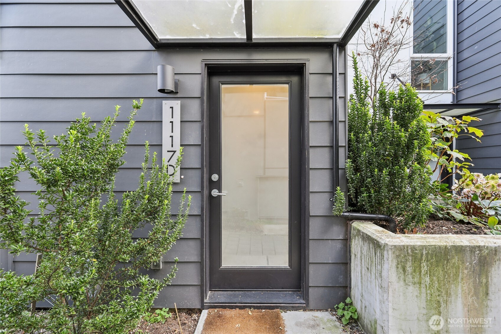 1117 Northwest 56th Street, Unit D Seattle, WA 98107 - Photo 3 of 32 a small garden in the backyard of a house