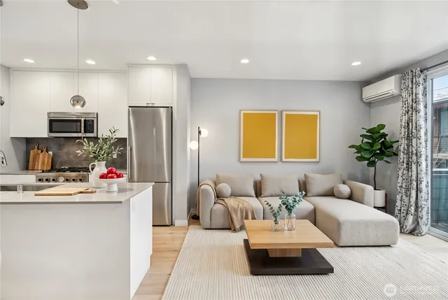 a living room with kitchen furniture and a wooden floor