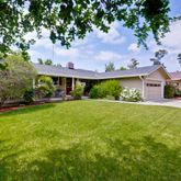 a front view of house with yard and green space