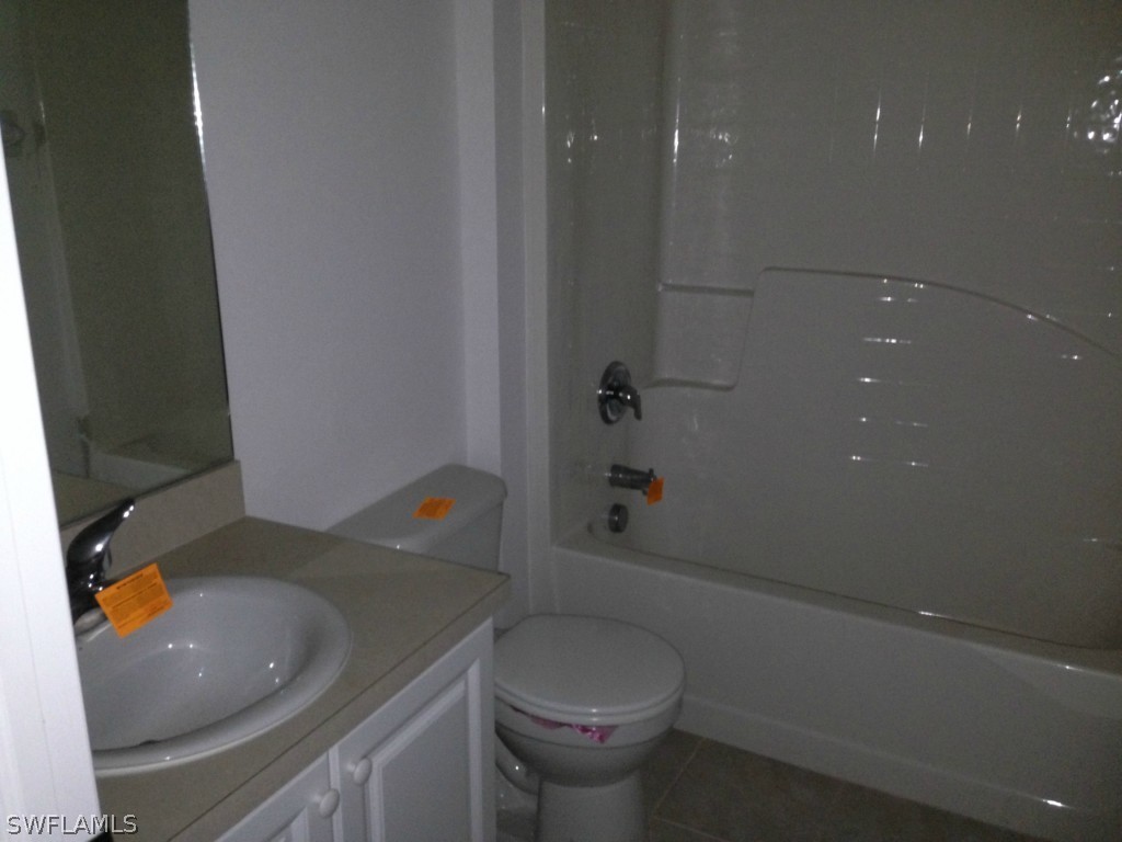3003 37th Street Southwest Lehigh Acres, FL 33976 - Photo 12 of 13 a bathroom with a sink toilet and shower