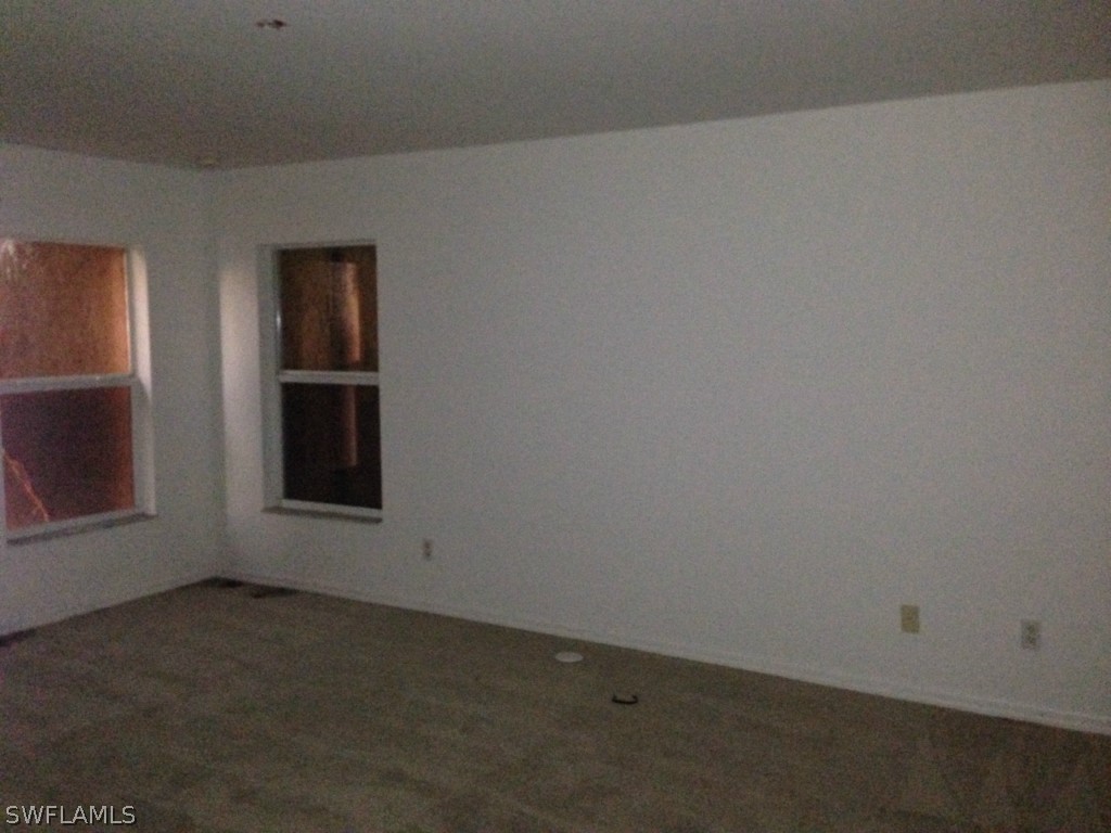3003 37th Street Southwest Lehigh Acres, FL 33976 - Photo 9 of 13 a room with a window