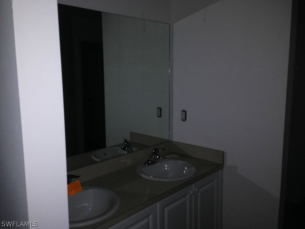3003 37th Street Southwest Lehigh Acres, FL 33976 - Photo 10 of 13 a bathroom with a sink and a toilet
