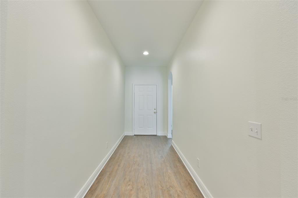 708 Coade Stone Drive Seffner, FL 33584 - Photo 19 of 48 a view of a hallway with wooden floor