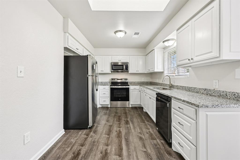 320 Edgewood Street Krum, TX 76249 - Photo 11 of 29 a kitchen with granite countertop a refrigerator stove top oven and sink