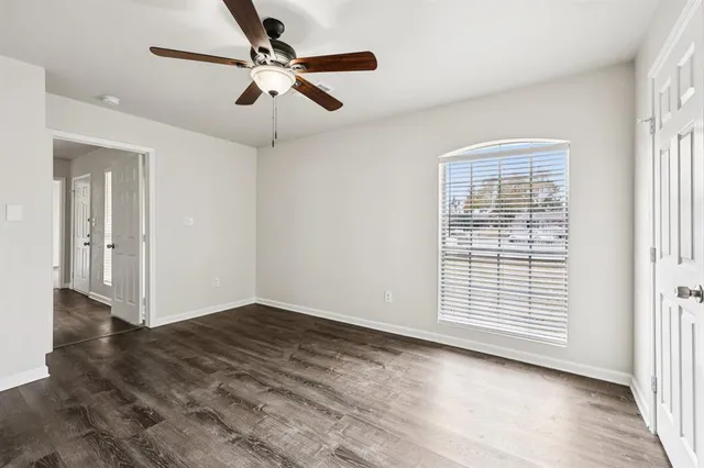 wooden floor in an empty room with a window