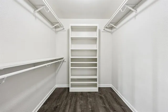 a view of walk in closet with empty racks