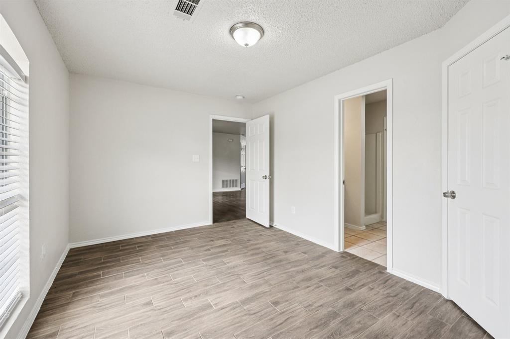 320 Edgewood Street Krum, TX 76249 - Photo 20 of 29 a view of an empty room with wooden floor and a window