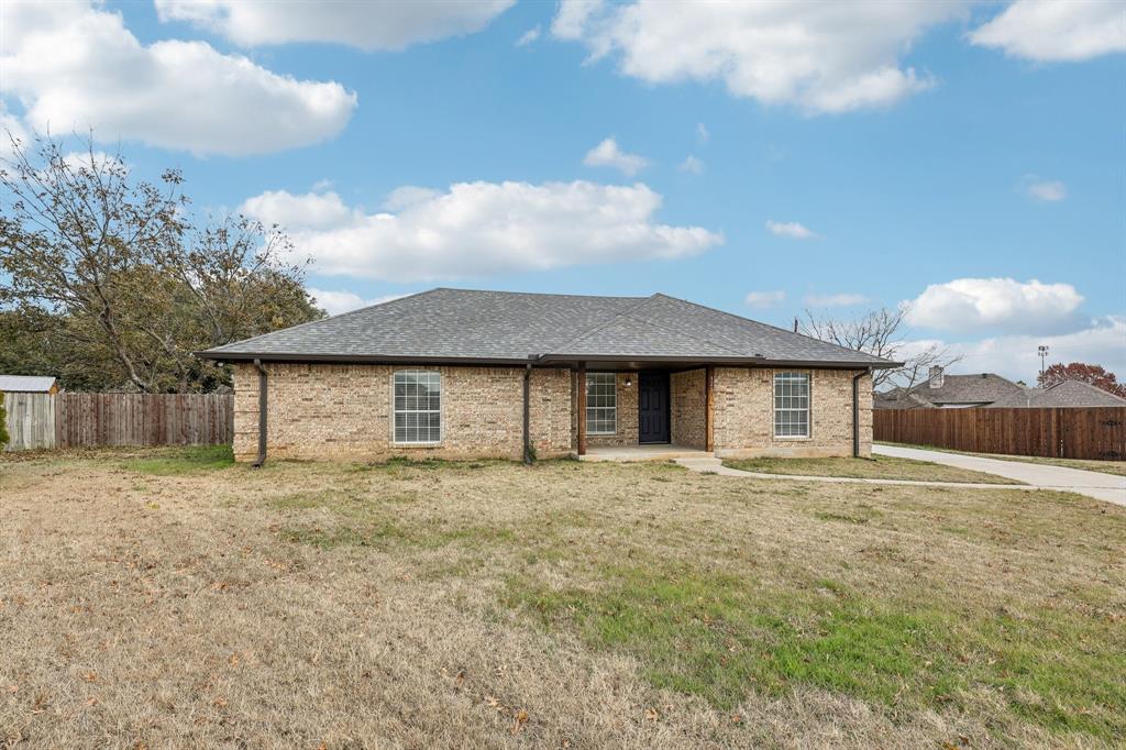 320 Edgewood Street Krum, TX 76249 - Photo 2 of 29 a front view of a house with a yard and garage