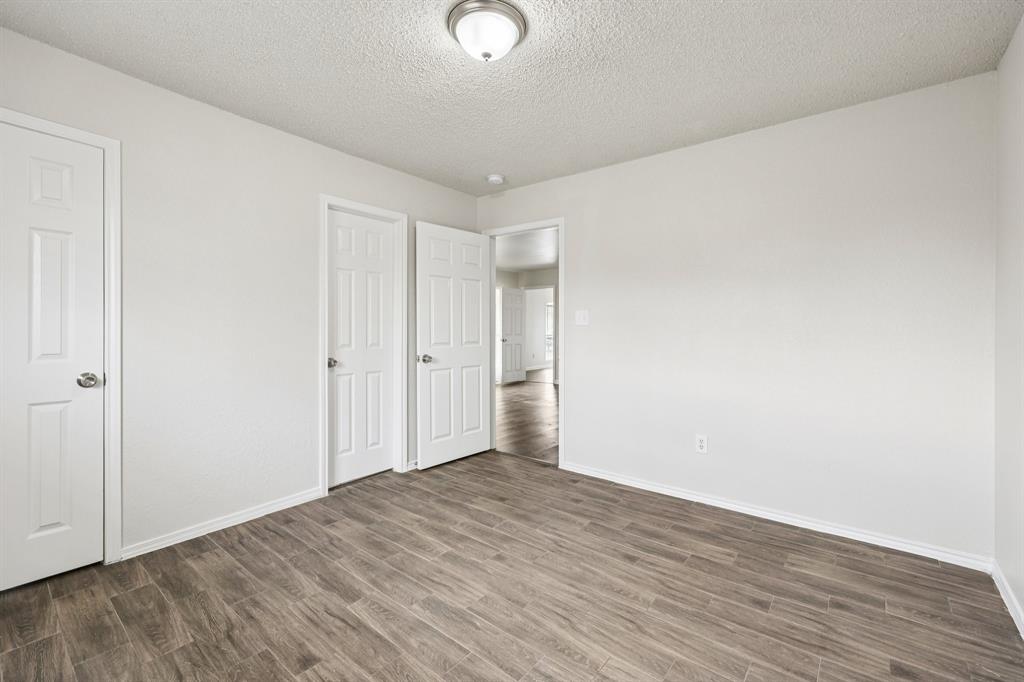 320 Edgewood Street Krum, TX 76249 - Photo 24 of 29 a view of an empty room with wooden floor