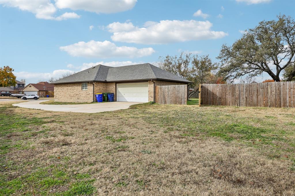 320 Edgewood Street Krum, TX 76249 - Photo 27 of 29 a front view of house with yard and trees