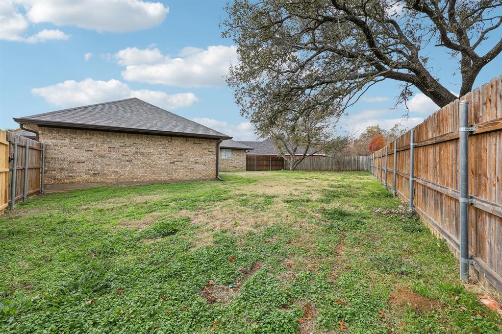 320 Edgewood Street Krum, TX 76249 - Photo 28 of 29 a backyard of a house with lots of green space