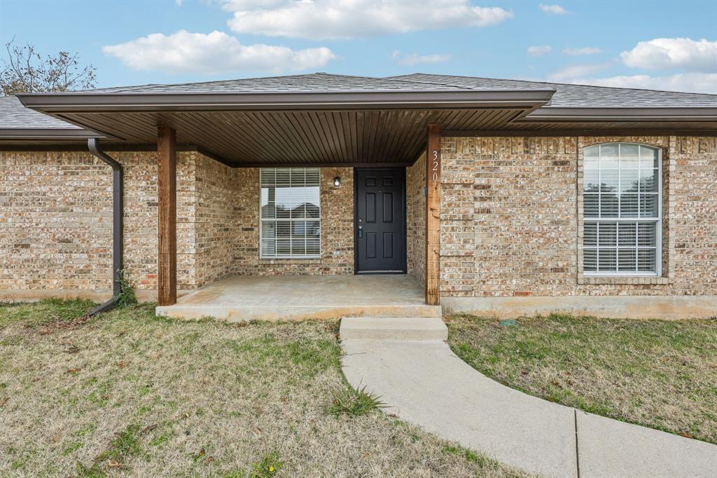 320 Edgewood Street Krum, TX 76249 - Photo 4 of 29 a front view of a house with a porch