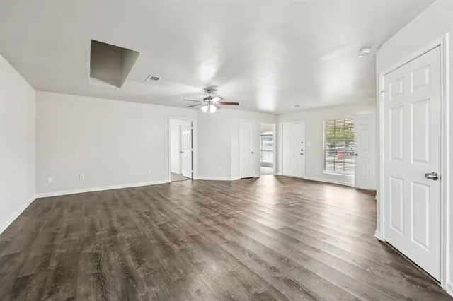 wooden floor in an empty room with a window