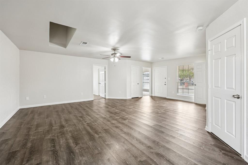 320 Edgewood Street Krum, TX 76249 - Photo 7 of 29 wooden floor in an empty room with a window