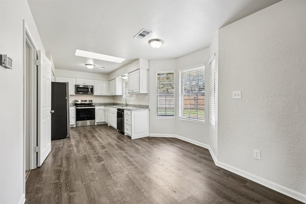 320 Edgewood Street Krum, TX 76249 - Photo 9 of 29 a view of kitchen with wooden floor electronic appliances and window