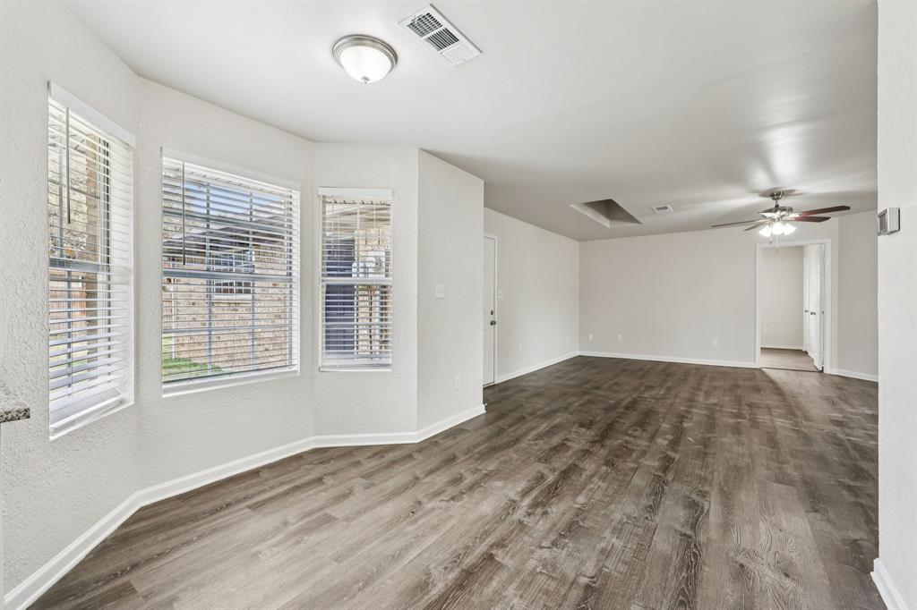 320 Edgewood Street Krum, TX 76249 - Photo 10 of 29 a view of empty room with wooden floor and fan