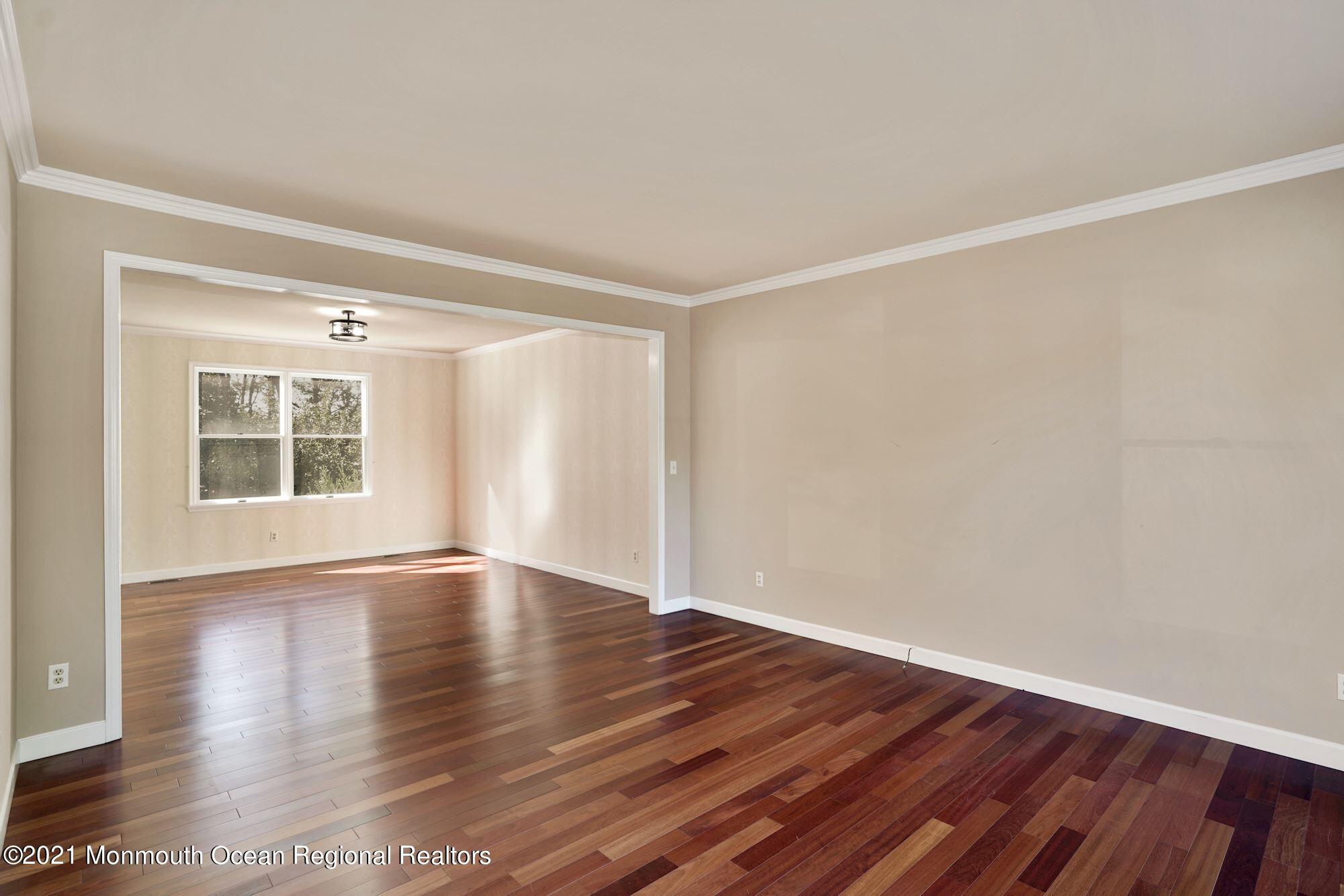 5 Roller Road Asbury Park, NJ 07712 - Photo 11 of 57 a view of an empty room with wooden floor and a window
