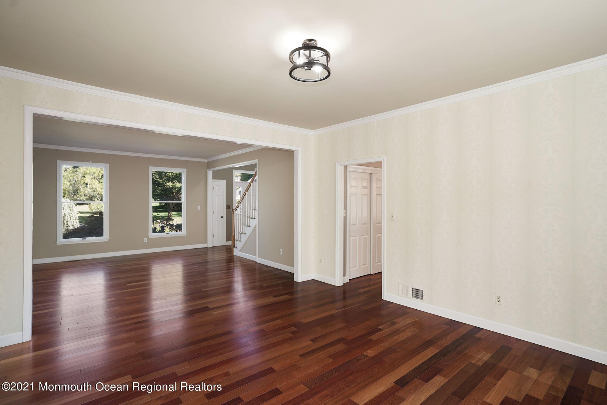 5 Roller Road Asbury Park, NJ 07712 - Photo 12 of 57 a view of an empty room with wooden floor and a window