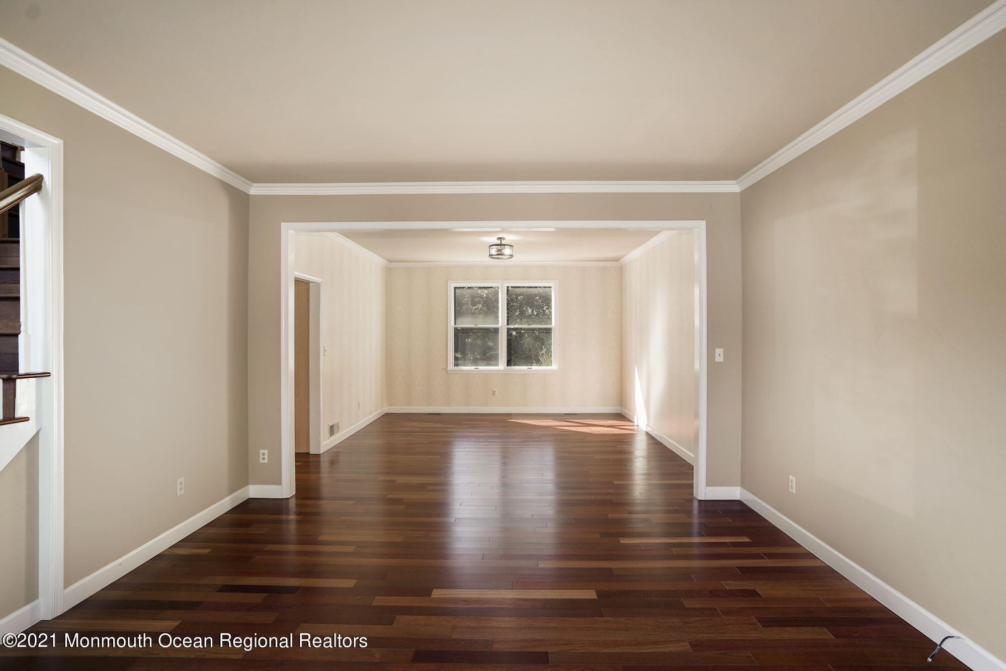 5 Roller Road Asbury Park, NJ 07712 - Photo 13 of 57 a view of empty room with wooden floor and fan