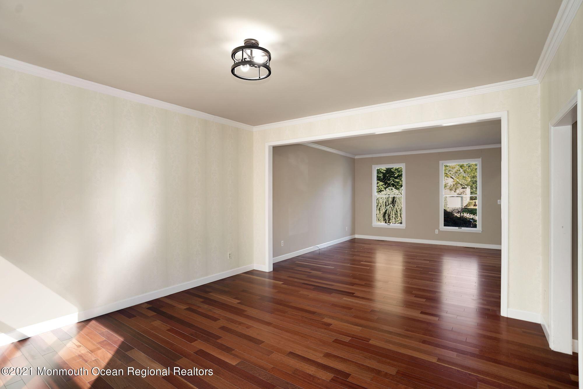 5 Roller Road Asbury Park, NJ 07712 - Photo 14 of 57 a view of an empty room with wooden floor and a window