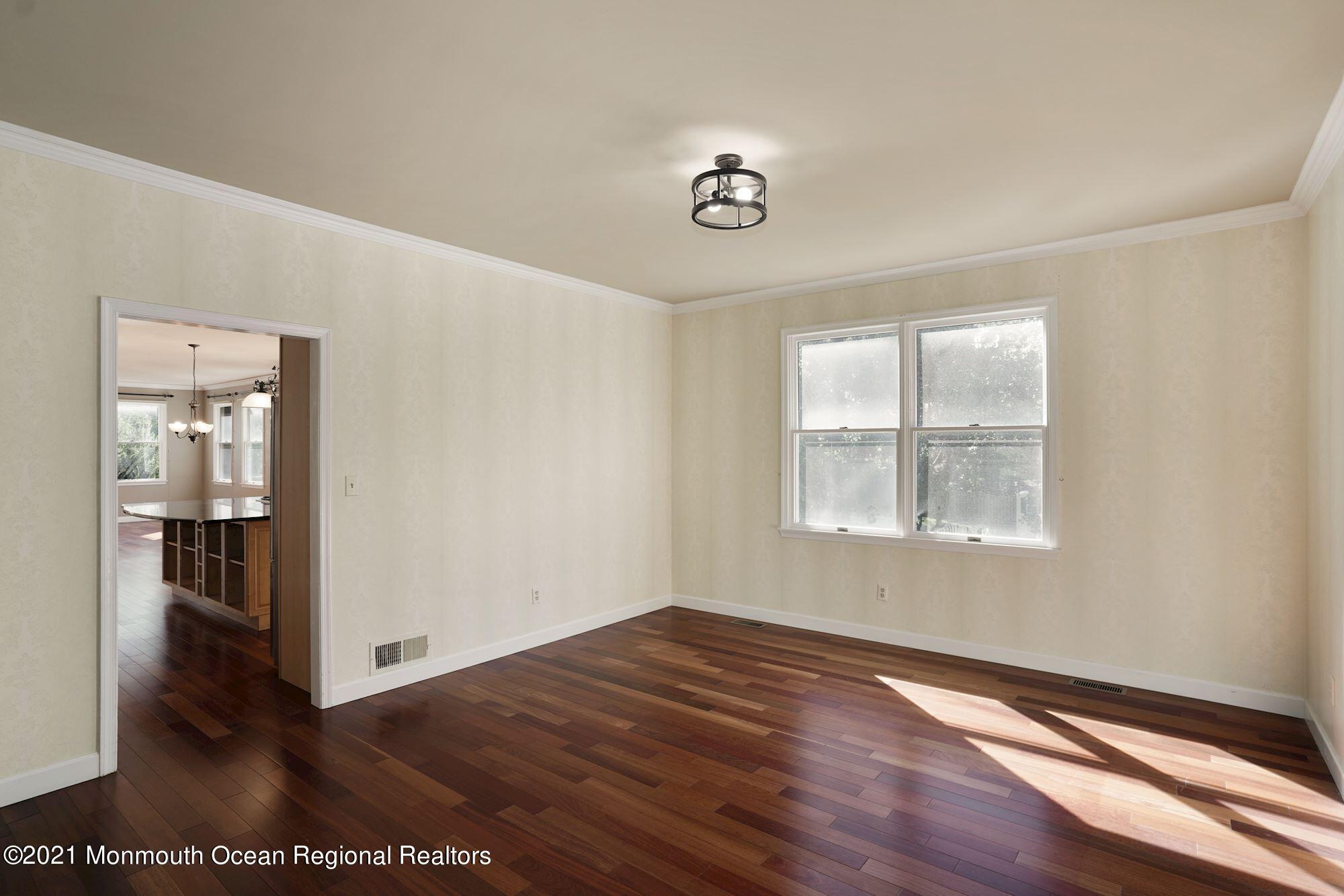 5 Roller Road Asbury Park, NJ 07712 - Photo 15 of 57 wooden floor in an empty room with a window