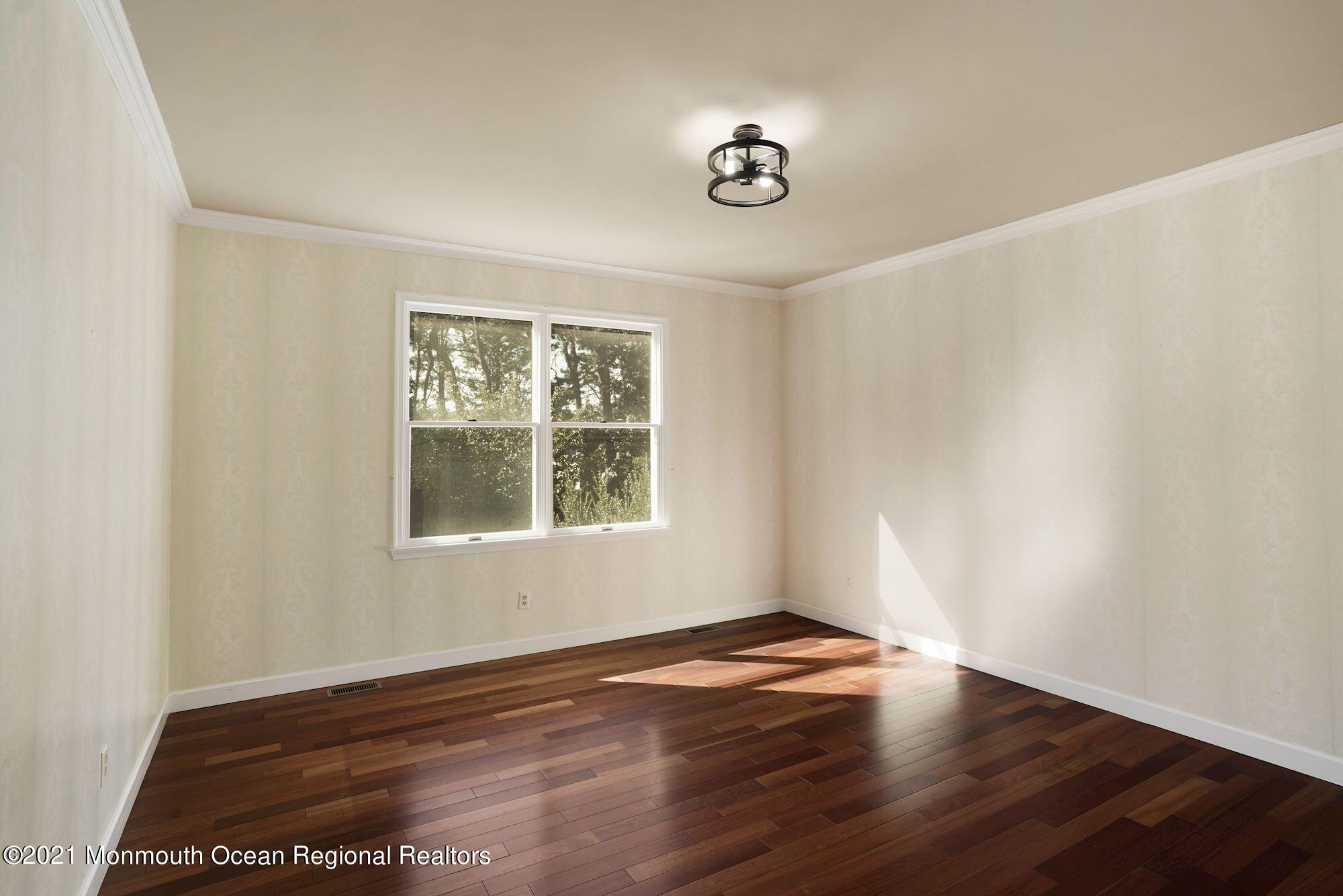 5 Roller Road Asbury Park, NJ 07712 - Photo 16 of 57 an empty room with wooden floor and windows