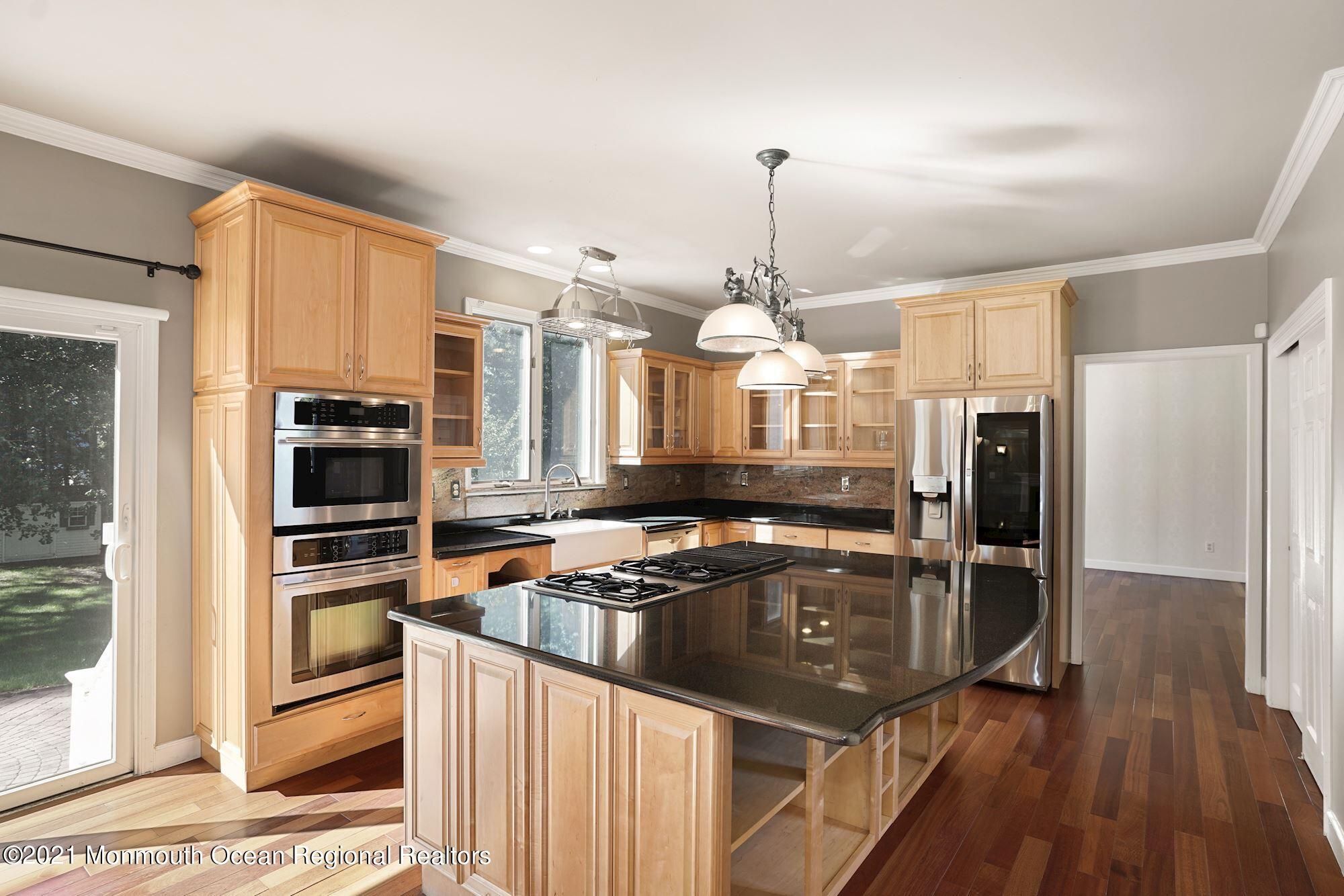 5 Roller Road Asbury Park, NJ 07712 - Photo 18 of 57 a kitchen with stainless steel appliances granite countertop a sink refrigerator and cabinets