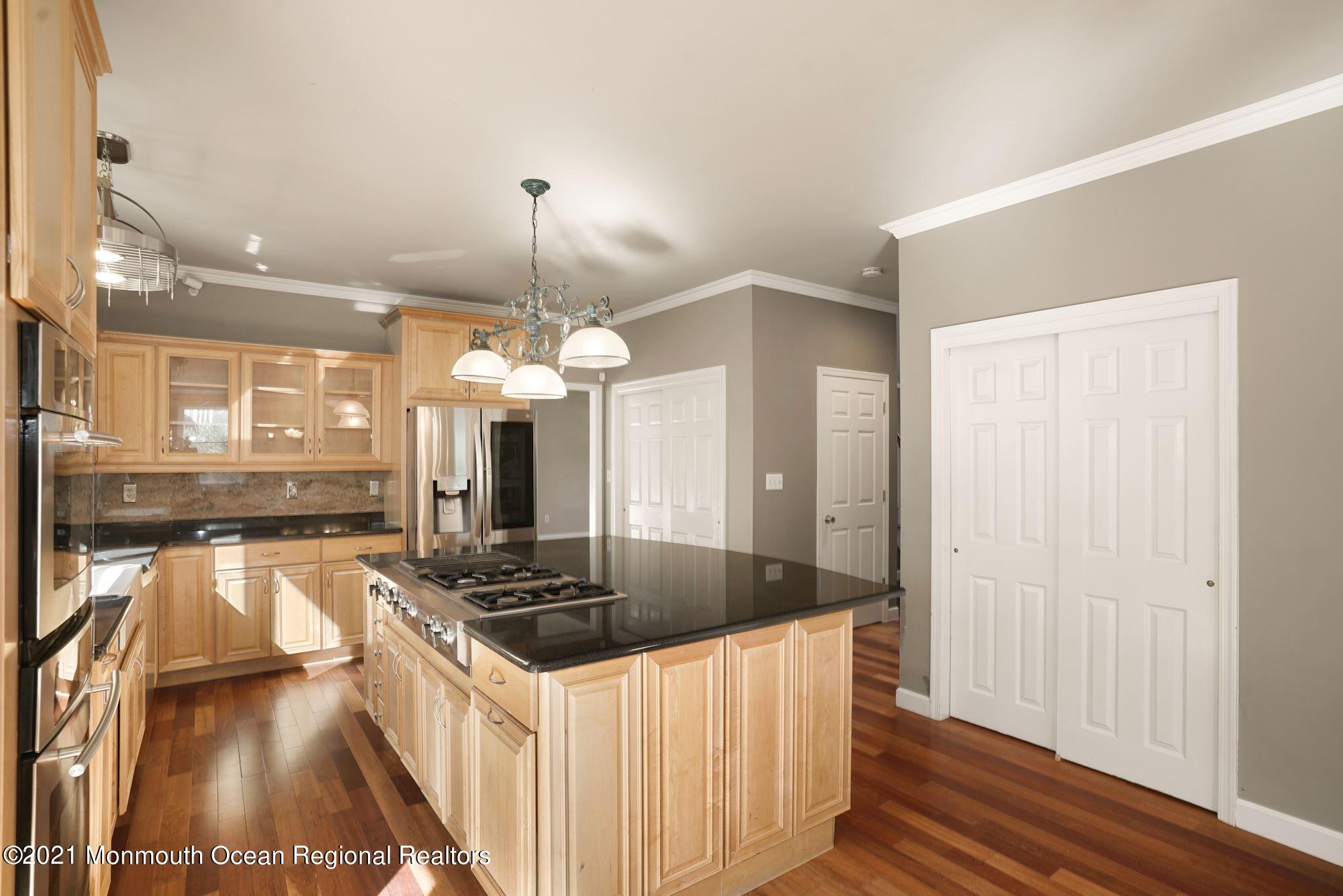 5 Roller Road Asbury Park, NJ 07712 - Photo 19 of 57 a kitchen with stainless steel appliances granite countertop a sink a stove and a wooden floors