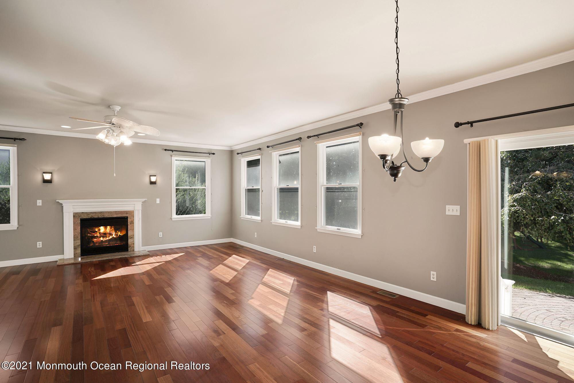5 Roller Road Asbury Park, NJ 07712 - Photo 25 of 57 a view of an empty room with wooden floor fireplace and a window