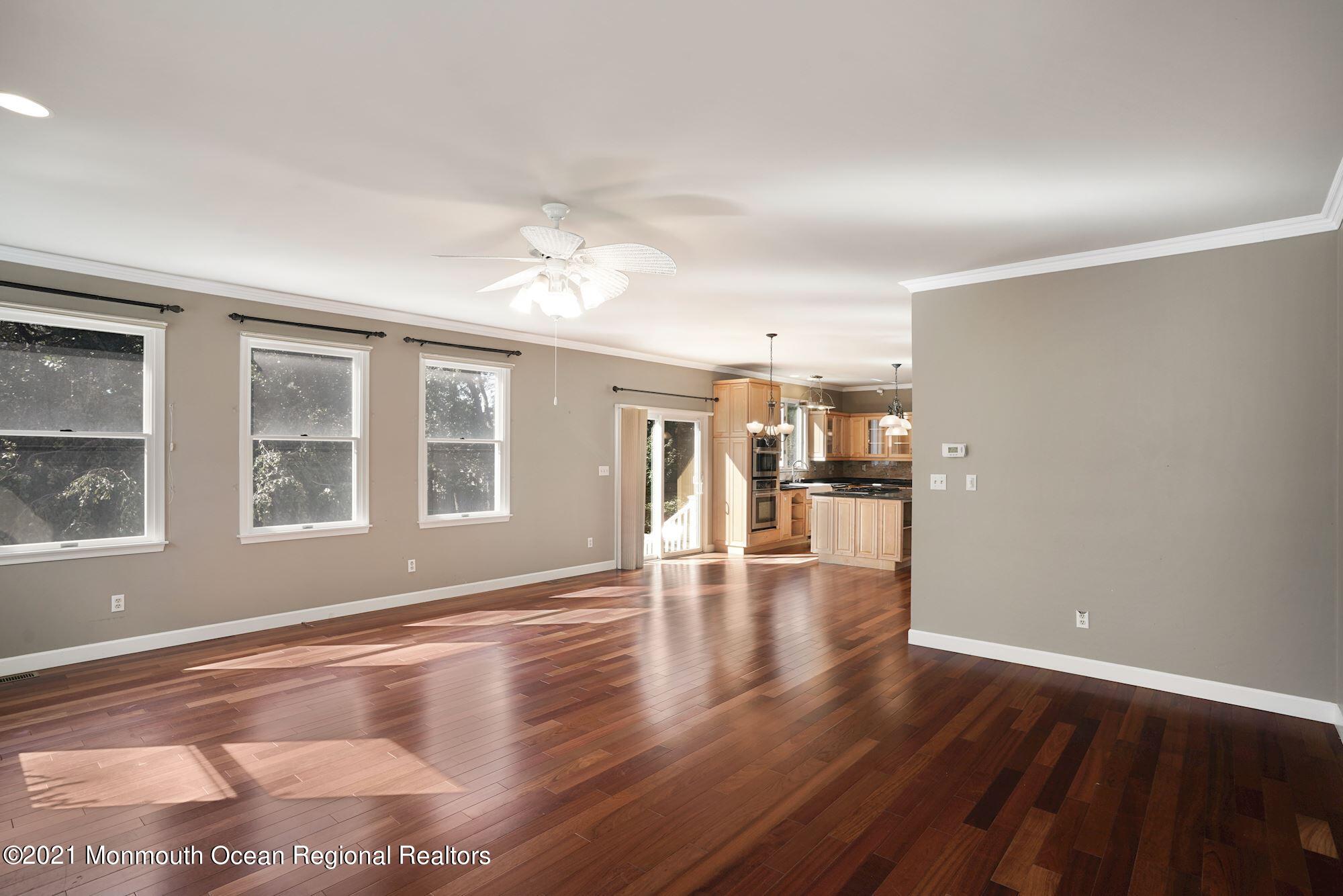 5 Roller Road Asbury Park, NJ 07712 - Photo 26 of 57 a view of an empty room with wooden floor and a window