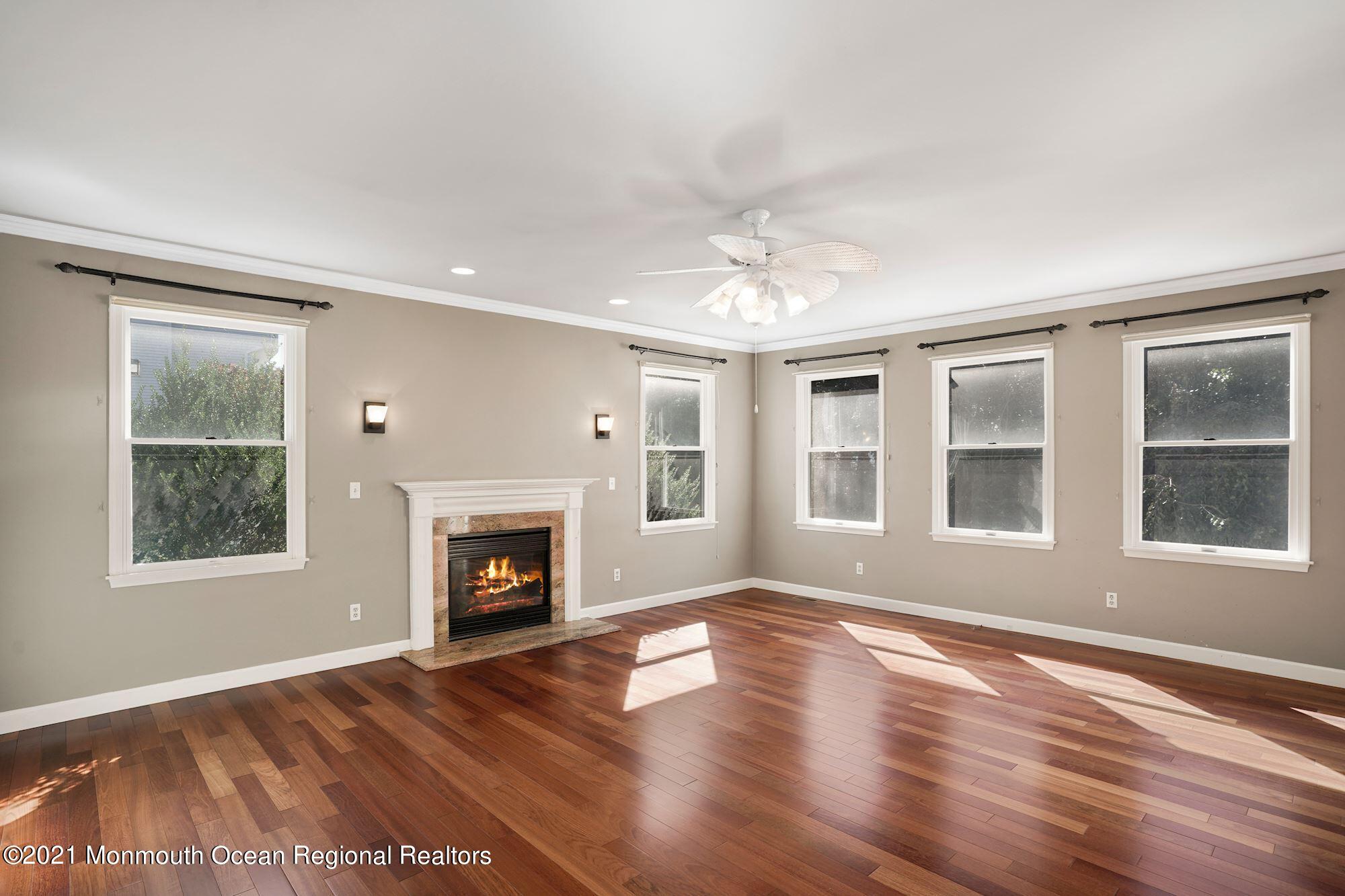 5 Roller Road Asbury Park, NJ 07712 - Photo 27 of 57 a view of an empty room with wooden floor and a window