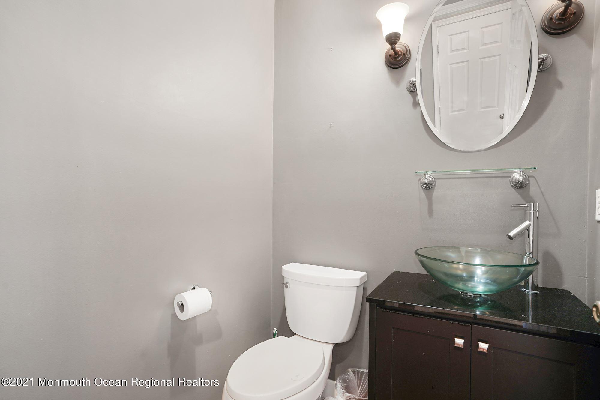 5 Roller Road Asbury Park, NJ 07712 - Photo 28 of 57 a bathroom with a toilet and a mirror