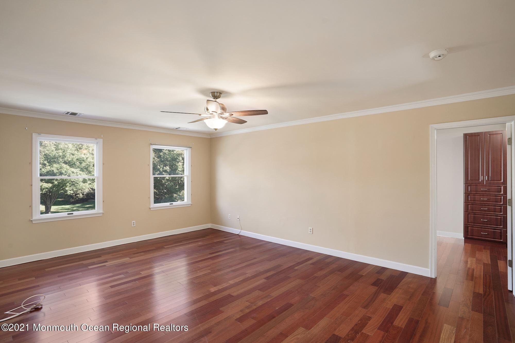 5 Roller Road Asbury Park, NJ 07712 - Photo 30 of 57 a view of an empty room with wooden floor and a window