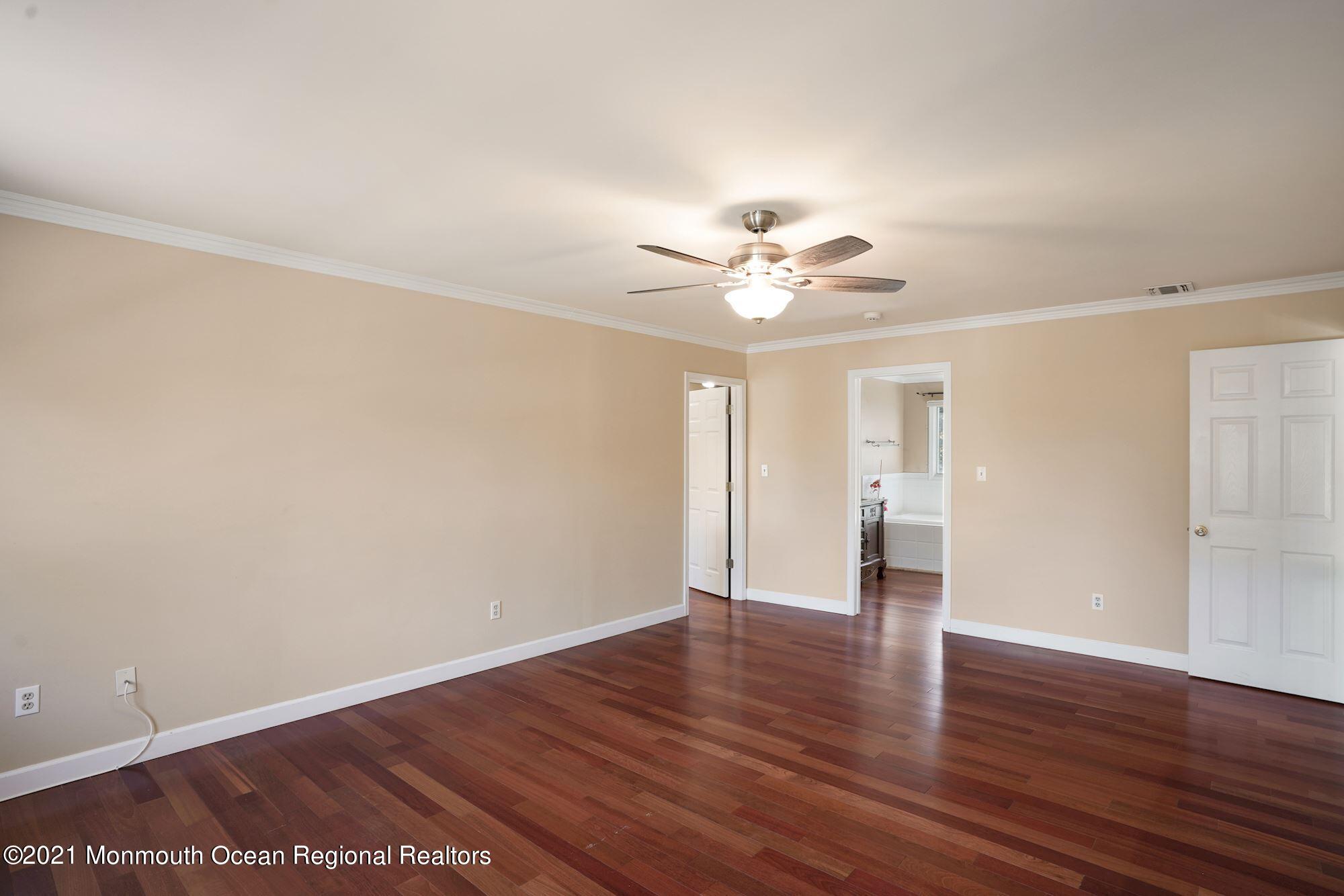 5 Roller Road Asbury Park, NJ 07712 - Photo 32 of 57 a view of an empty room with a window and wooden floor
