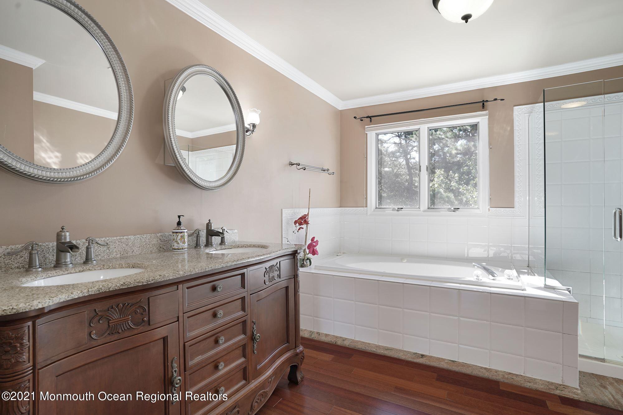 5 Roller Road Asbury Park, NJ 07712 - Photo 33 of 57 a bathroom with a tub sink and mirror