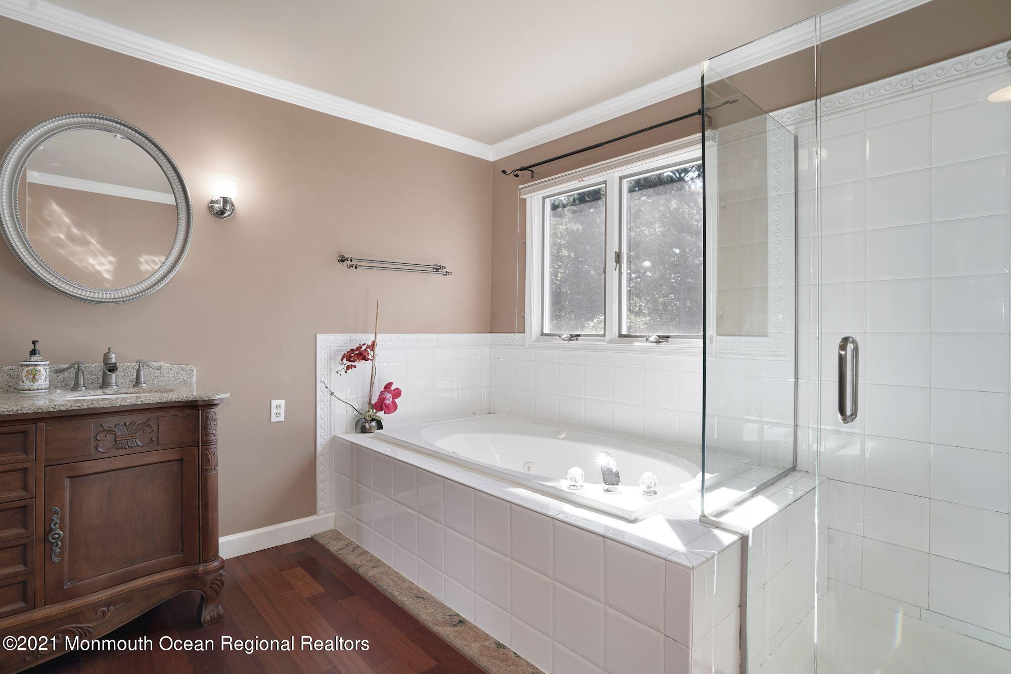 5 Roller Road Asbury Park, NJ 07712 - Photo 34 of 57 a bathroom with a tub sink and mirror