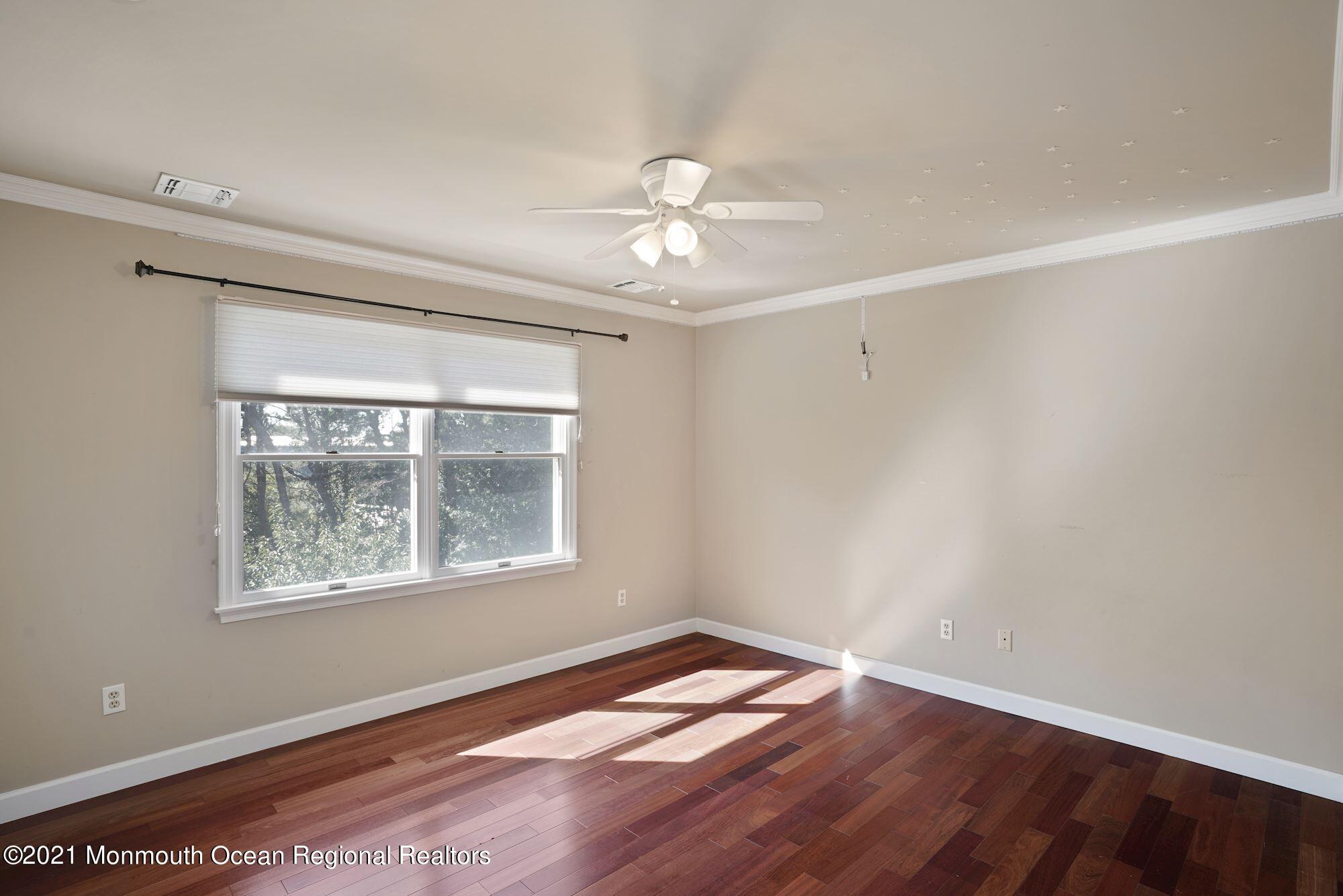 5 Roller Road Asbury Park, NJ 07712 - Photo 38 of 57 a view of an empty room with wooden floor and a window
