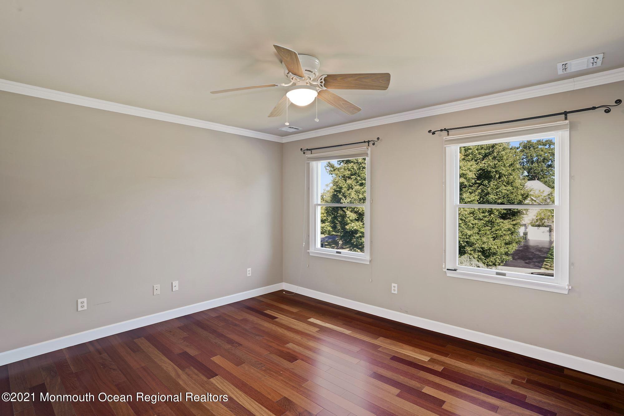 5 Roller Road Asbury Park, NJ 07712 - Photo 40 of 57 a view of an empty room with wooden floor and a window