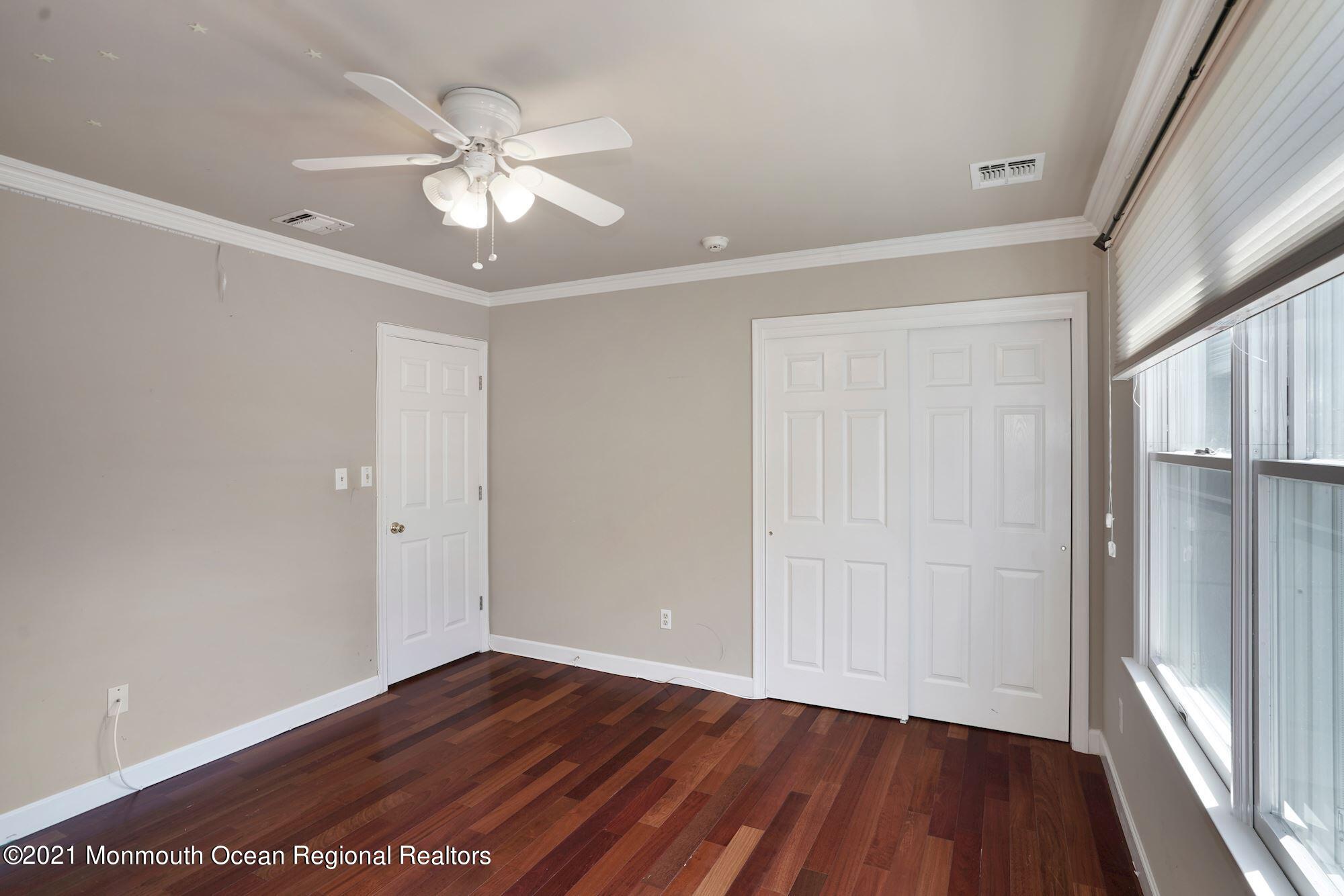 5 Roller Road Asbury Park, NJ 07712 - Photo 41 of 57 a view of an empty room with wooden floor and a window