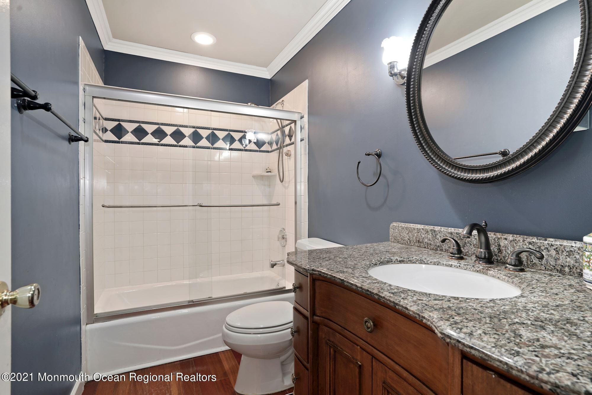 5 Roller Road Asbury Park, NJ 07712 - Photo 42 of 57 a bathroom with a granite countertop sink mirror vanity and toilet