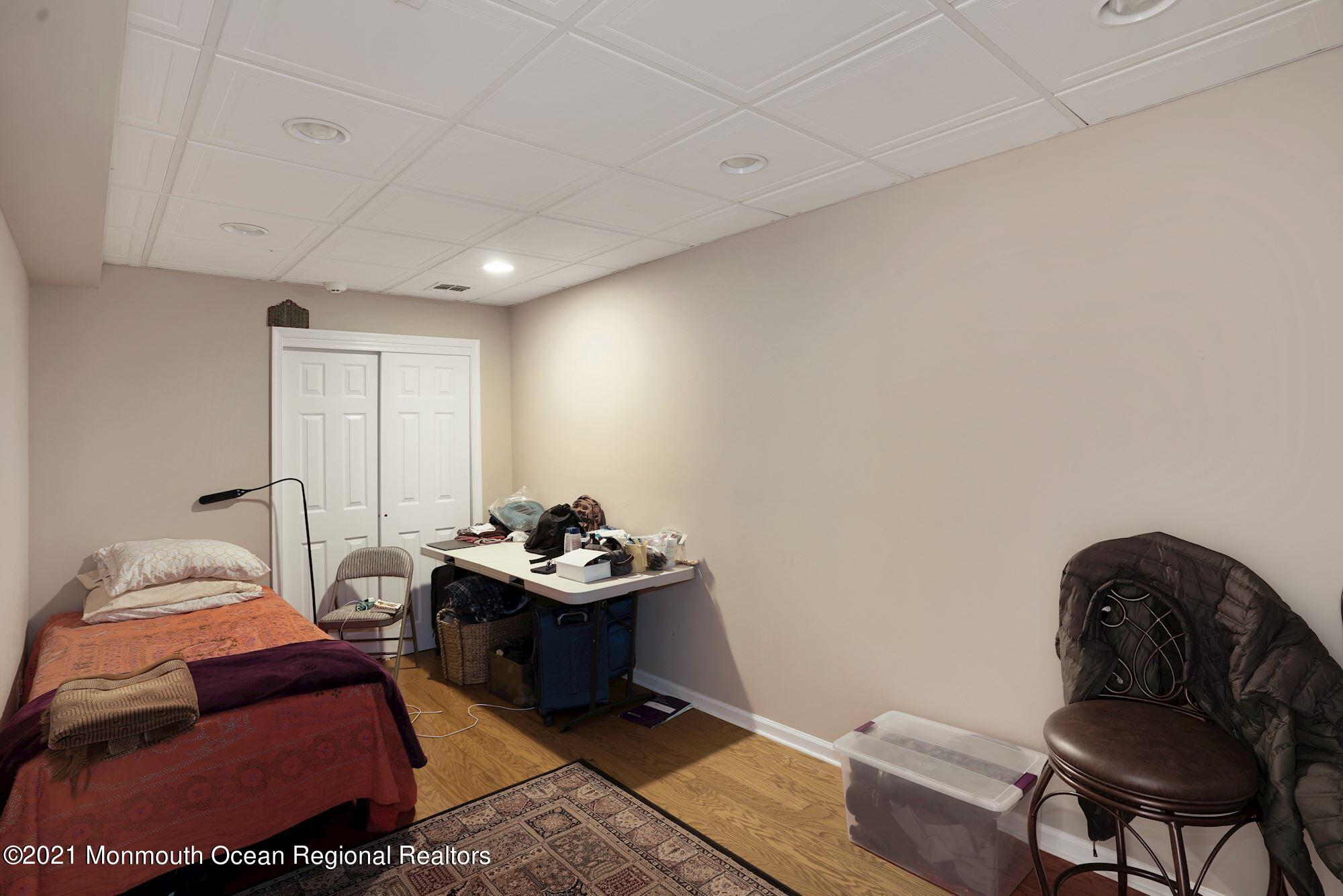 5 Roller Road Asbury Park, NJ 07712 - Photo 50 of 57 a bedroom with furniture and a chair