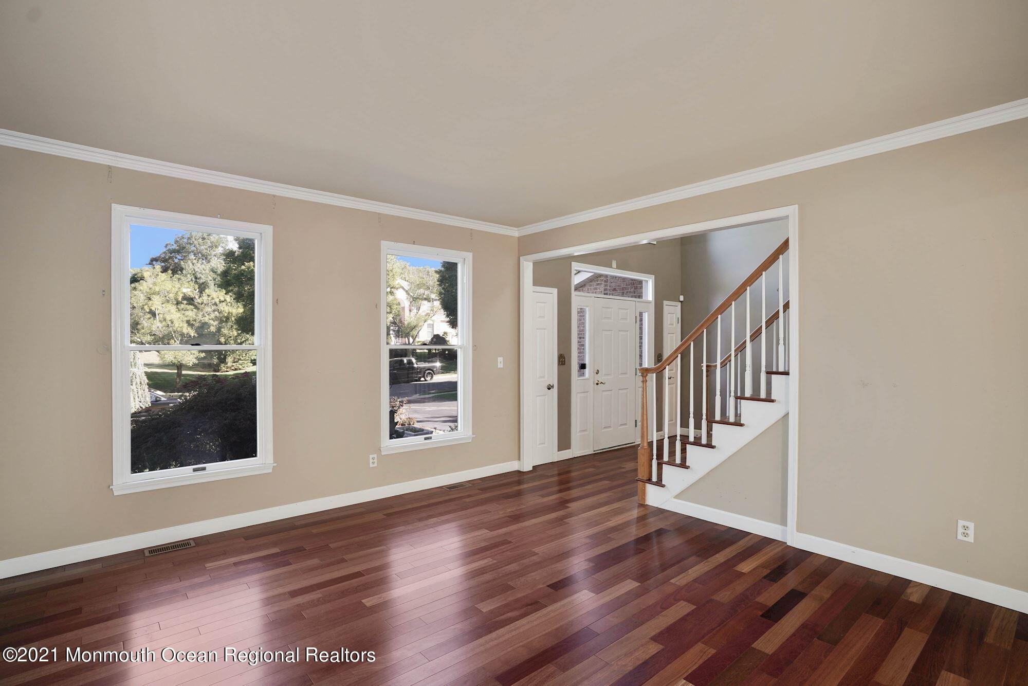 5 Roller Road Asbury Park, NJ 07712 - Photo 8 of 57 a view of an empty room with wooden floor and a window