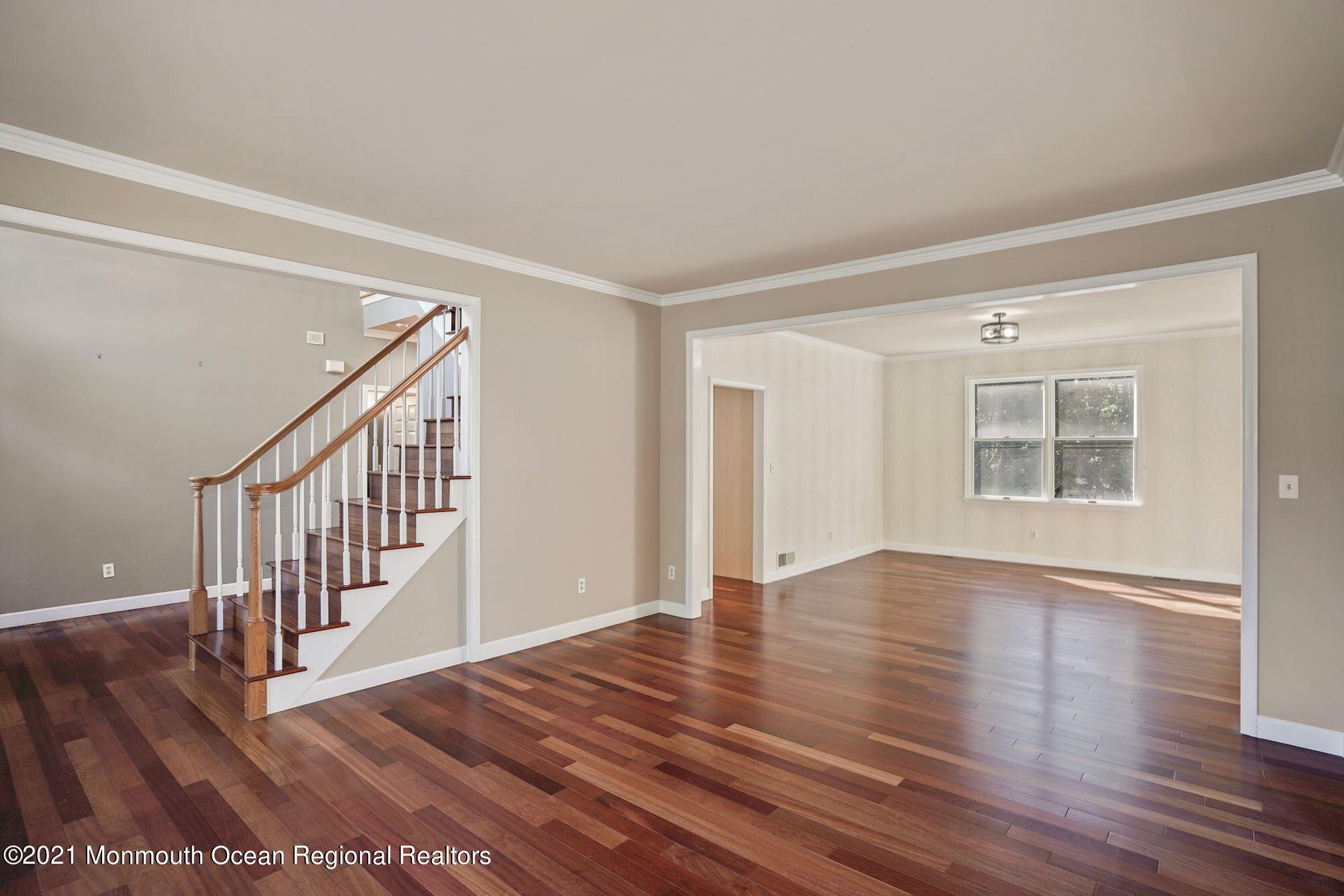 5 Roller Road Asbury Park, NJ 07712 - Photo 9 of 57 a view of an empty room with wooden floor and a window