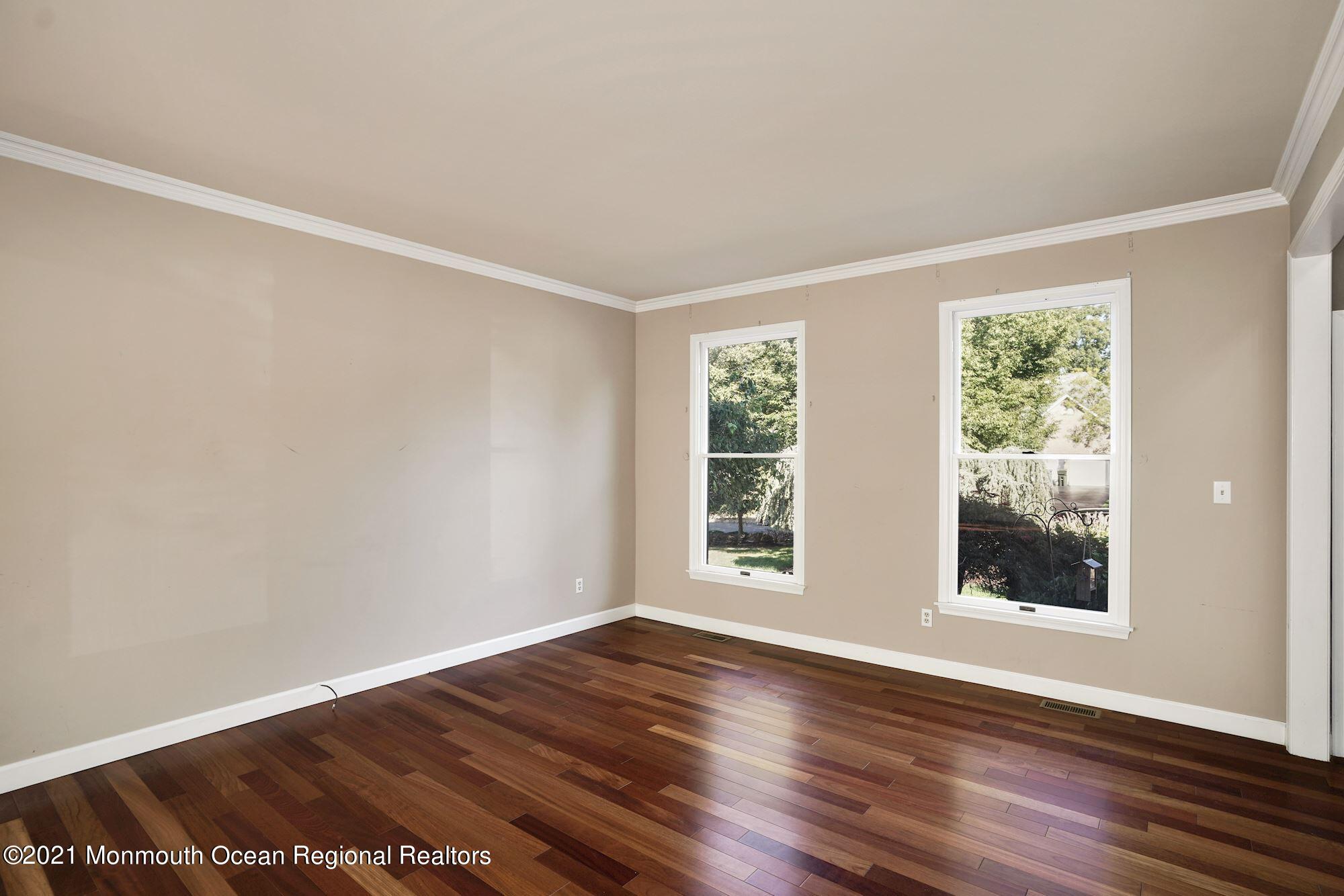 5 Roller Road Asbury Park, NJ 07712 - Photo 10 of 57 a view of an empty room with wooden floor and a window